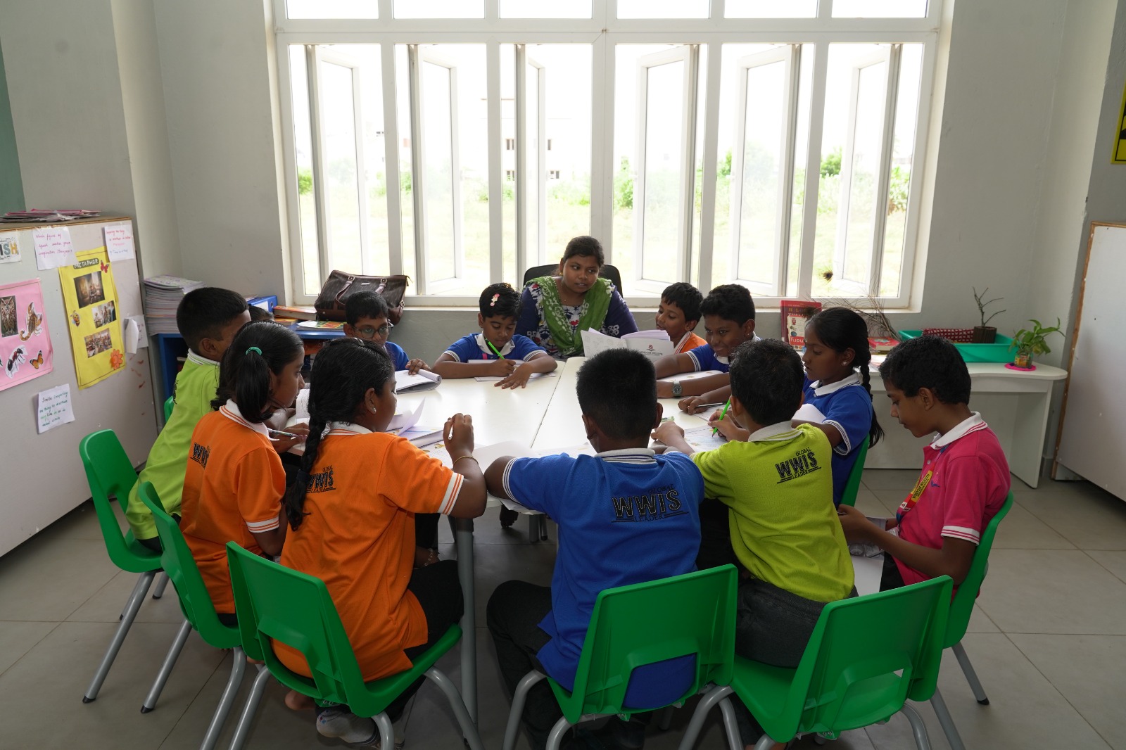 Teacher leading a group discussion with students during Language Hour