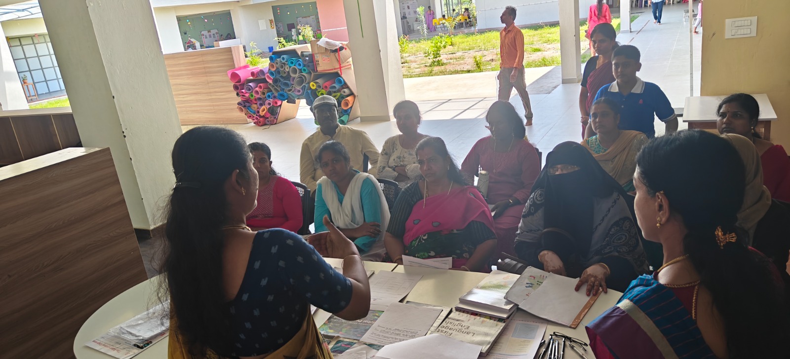 Parents submitting their admission application with WWIS staff