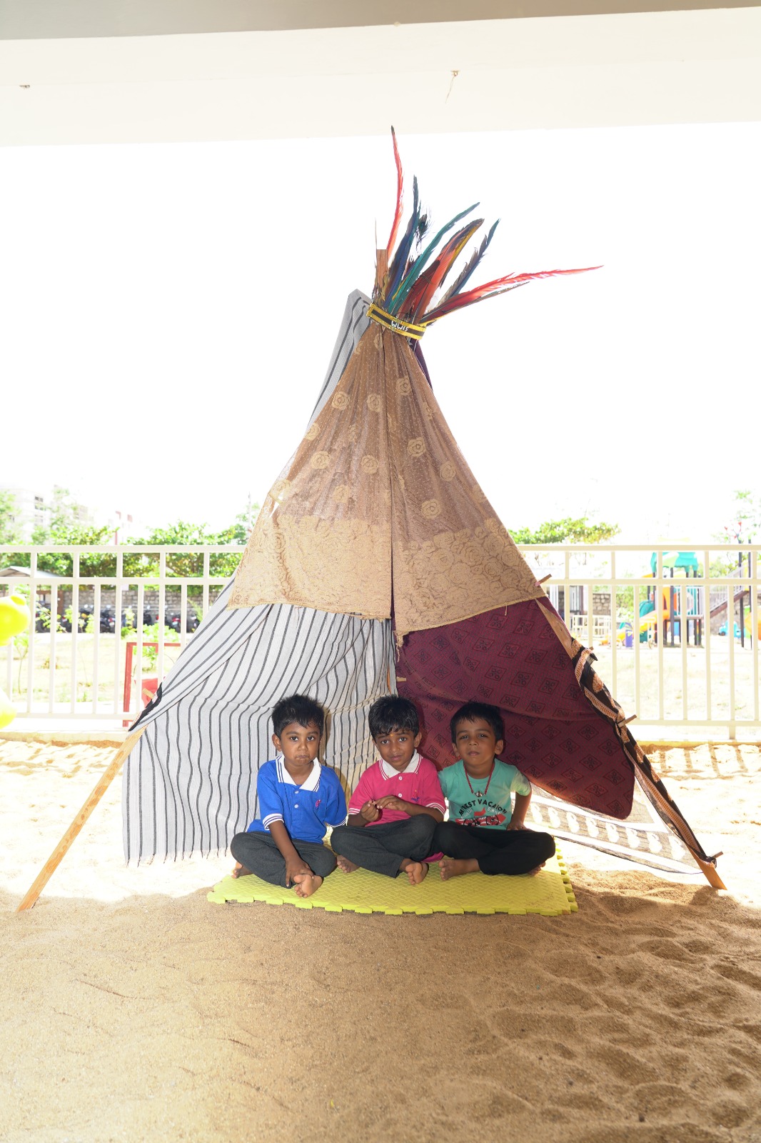 Students playing inside an imaginative play tent