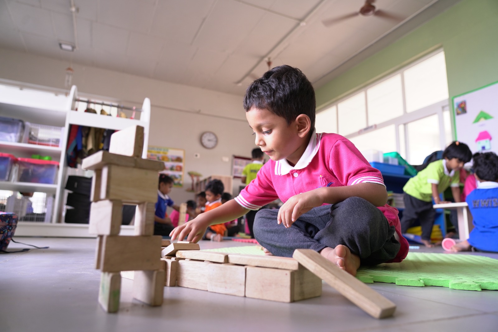 Student independently building with wooden blocks